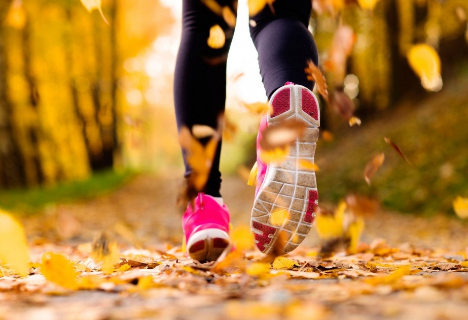 Person moving gracefully from one yoga pose to another in a spacious studio.